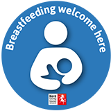 Breastfeeding welcome logo. A blue circular sticker with Kent County Council's logo that businesses may display to indicate they are safe places to breastfeed. It clearly states, 'Breastfeeding welcome here'.