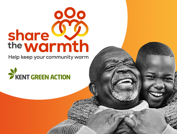 A father and son hugging and smiling wearing jumpers. Text inside the image reads 'Share the warmth, help keep your community warm, from Kent Green Action'