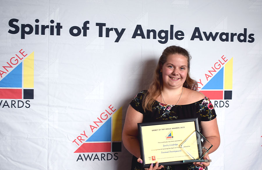 Image of Emily Lindridge accepting the Spirit Winner for Personal Development award